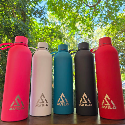 Set of colorful water bottles with a brand logo against a natural background