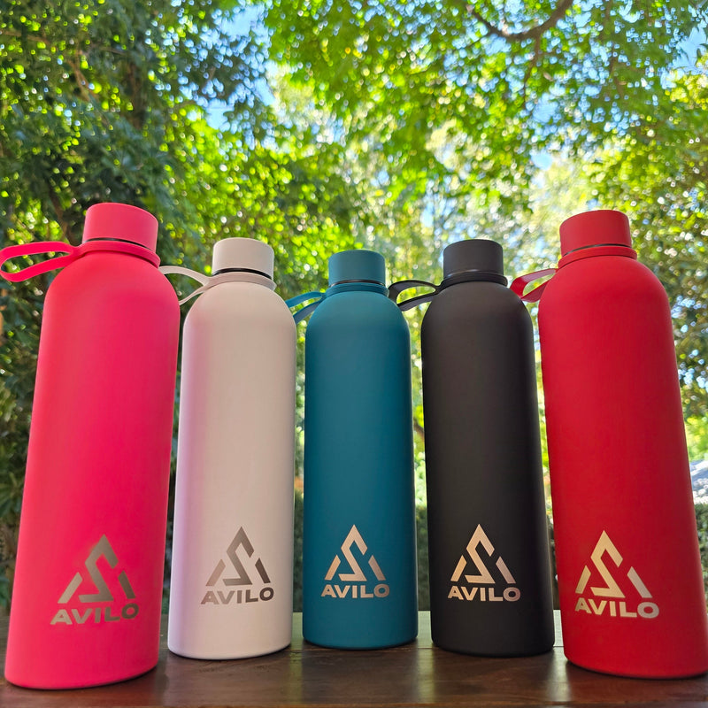 Set of Avilo Summit Range insulated flasks in five colours on a natural background