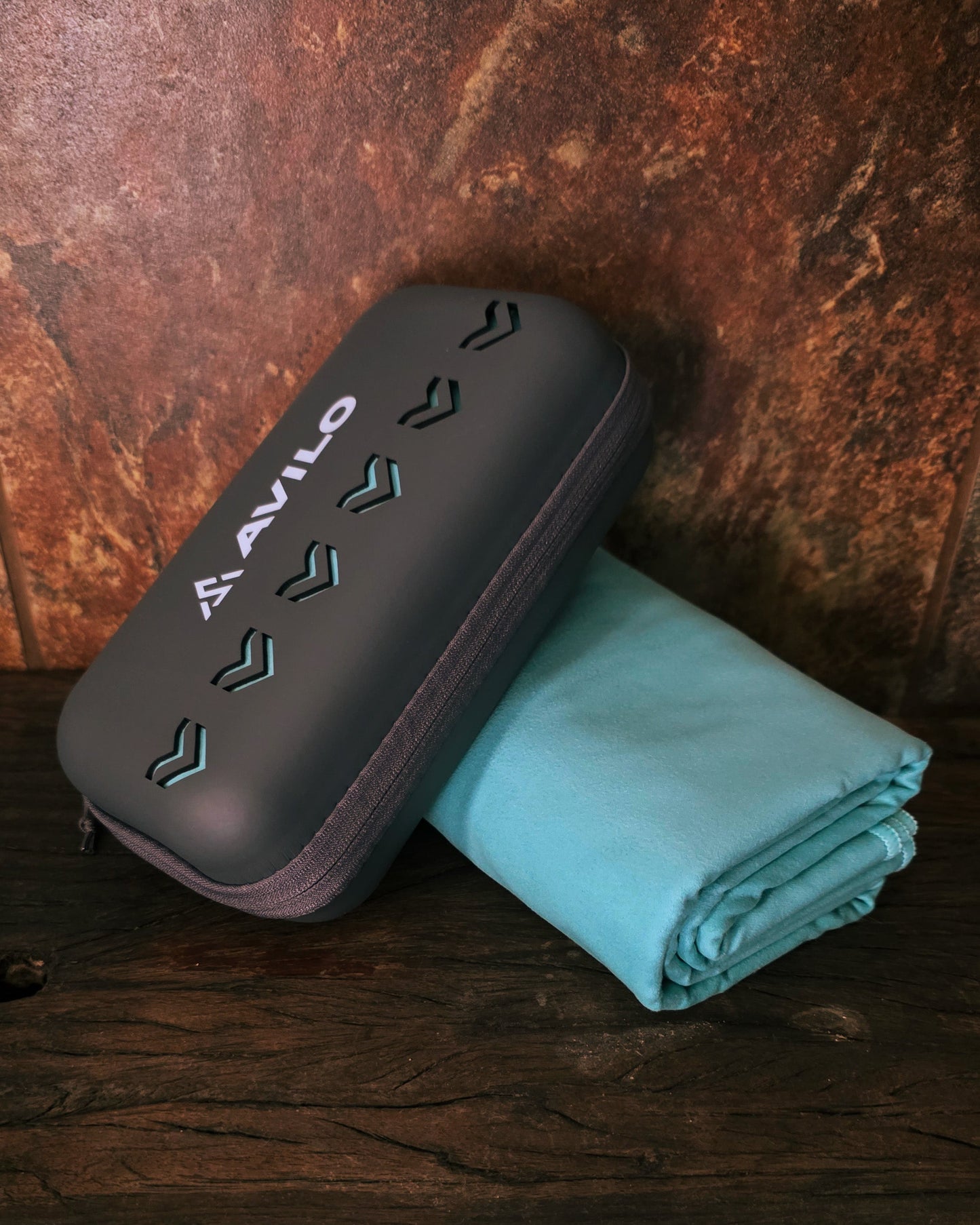 Black electronic device with a teal cloth on a wooden surface