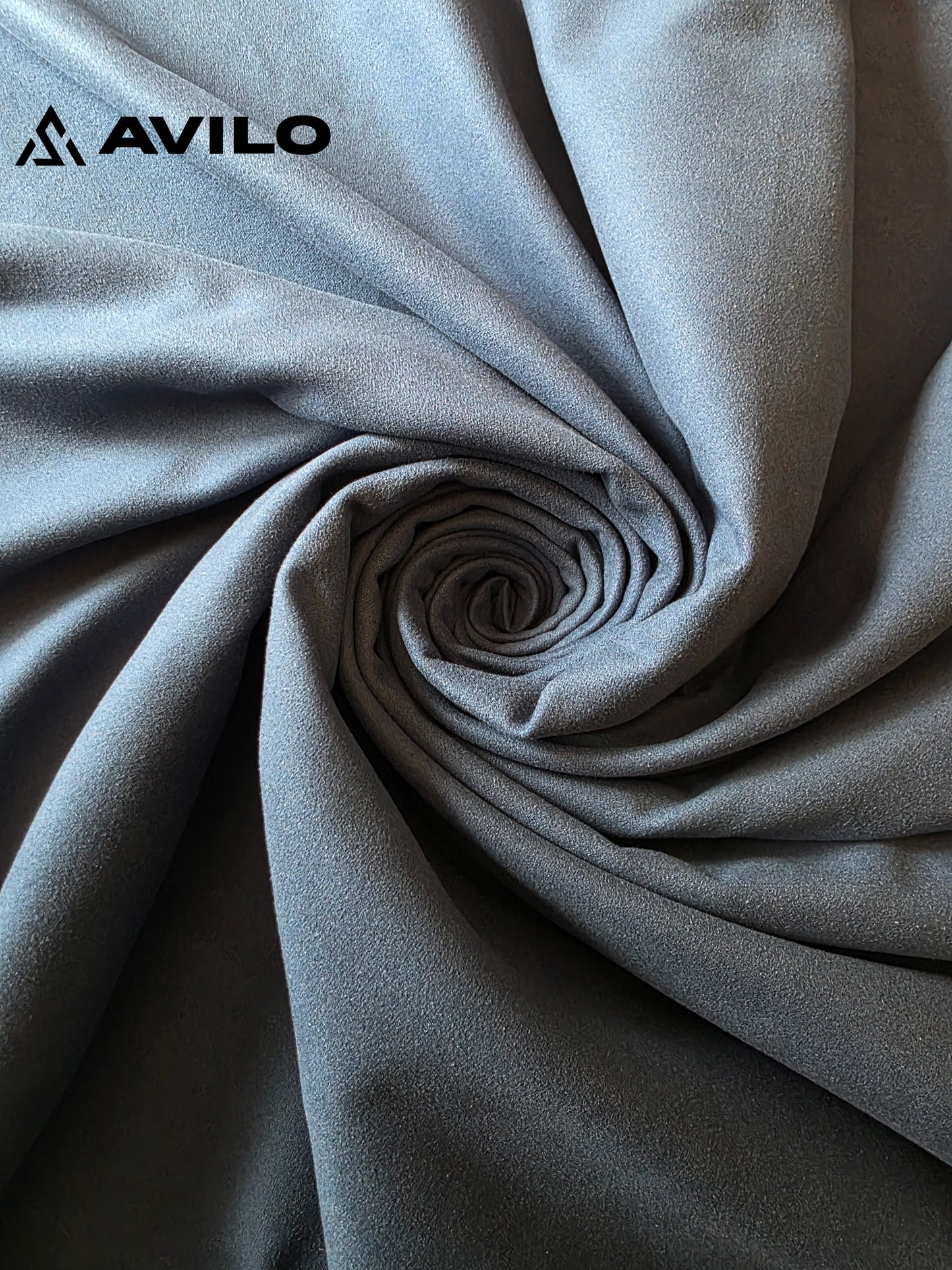 Close-up of gray fabric with Avilo logo in the corner