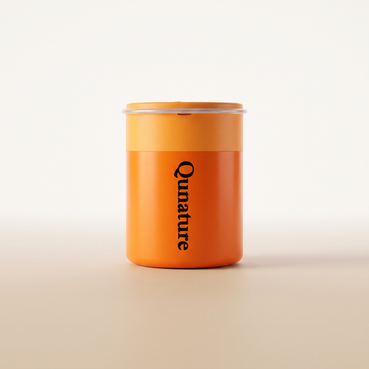 The orange Qunature Atomic Pump seen from the front on a plain cream background :: Orange