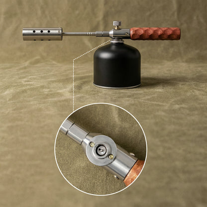 The torch on a threaded gas canister, with a close-up of the gas connection on the underside of the valve