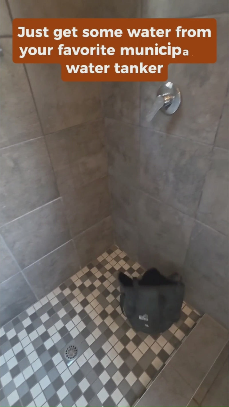 Filling the included 20 litre bucket and lowering the Avilo shower pump into it.